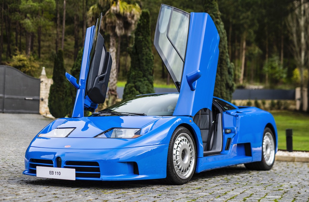 A blue car with doors openDescription automatically generated with medium confidence