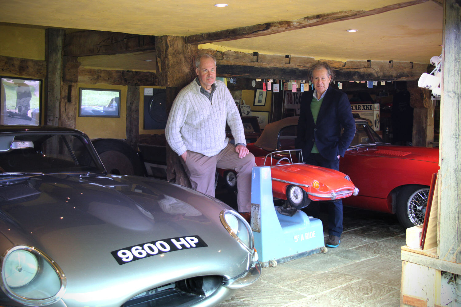 Mark + Philip with E-Type 9600 HP , which Philip Porter owned for 49 years - the oldest E-type in existence, was a prototype built in 1960, used for development testing in late 1960/early 1961 and then became the Press Fixed Head Coupe and was used for the Geneva launch in March, 1961, having been driven flat out from Coventry, arriving with 20 minutes to spare. The red Roadster in the background, 848 CRY, was the 12th made, raced in 1961 as 2 BBC and later in the film The Italian Job with Sir Michael Caine.